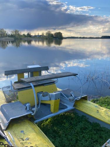 a boat with a picnic table on a lake at Širvėnos namai - penkiavietis numeris in Biržai