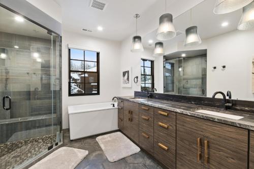 a bathroom with a shower and a sink and a tub at Slopeside 129 in Whitefish