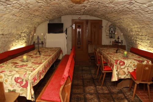 a room with three tables and a bed in it at Hotel Altes Rittergut in Sehnde