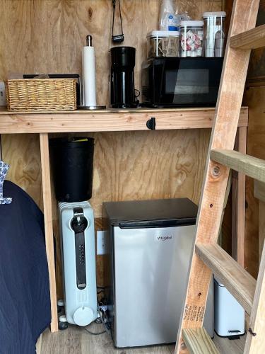 a kitchen with a coffee maker and a blender on a shelf at High Country-The Well House in Blowing Rock