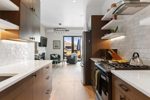 a kitchen with white counters and a stove top oven at Alpenglow Retreat in Whitefish