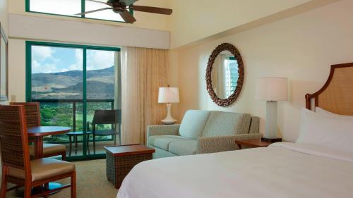 a hotel room with a bed and a couch and a window at HAWAII-OAHU - Marriott Ko Olina Beach Club Resort in Kapolei