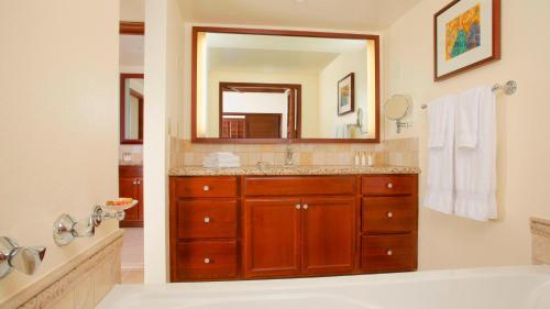 a bathroom with a sink and a large mirror at HAWAII-OAHU - Marriott Ko Olina Beach Club Resort in Kapolei