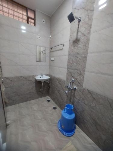 a bathroom with a shower and a sink at Shivaganga Comforts in Bengaluru