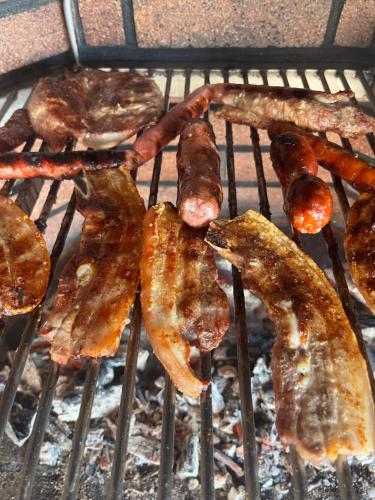 a group of bacon and sausage on a grill at Casa Mararía in Gran Tarajal
