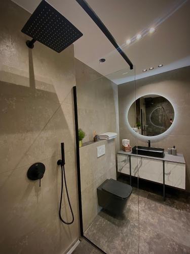 a bathroom with a shower with a toilet and a sink at Villa 5 in Makarska