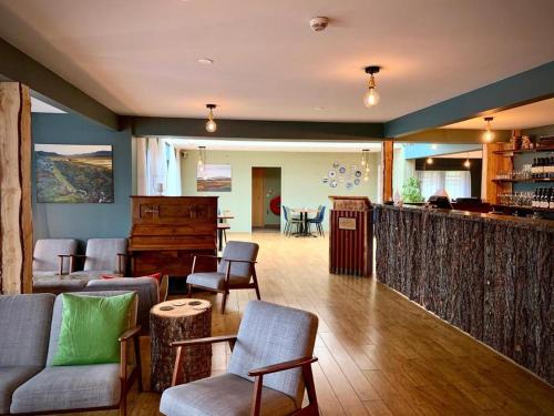 ein Wohnzimmer mit einer Bar, Stühlen und einer Theke in der Unterkunft Hotel Breiddalsvik in Breiðdalsvík