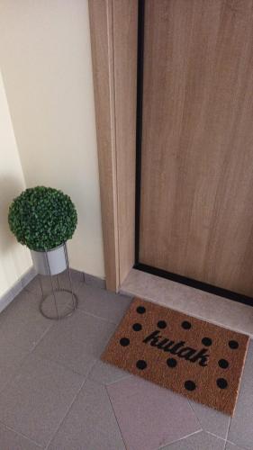 a welcome mat in front of a door with a plant at kutak in Sesvete