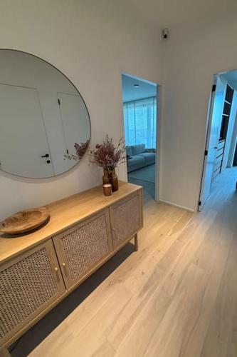 a room with a large mirror on top of a dresser at Enjoy the Belgian coast with indoor heated swimmingpool and fitness in Ostend