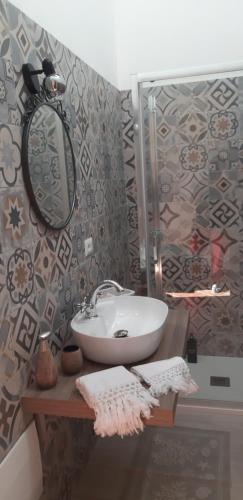 a bathroom with a sink and a mirror at Casa Logos Stintino Country Paradise in Stintino