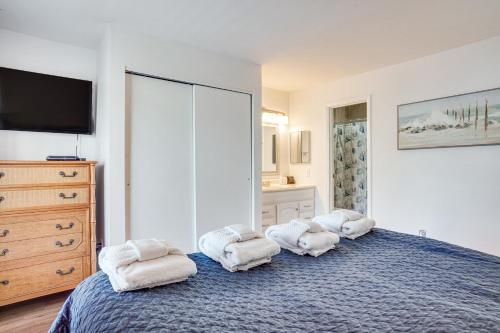 a bedroom with a bed with towels on it at Harbor Island Condo with Pool Access Walk to Beach! in Oceanmarsh Subdivision