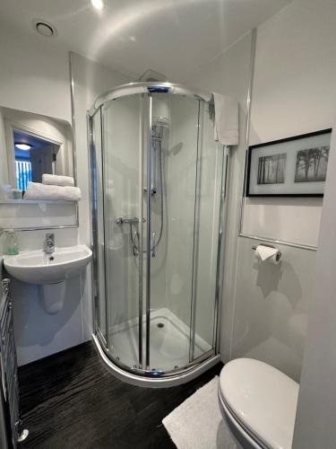a bathroom with a shower and a toilet at Third House Guest House in Aberdeen
