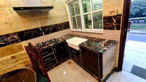 a bathroom with a sink and a counter top at B&B Apartment & Hotels in Lahore