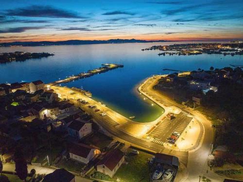 an aerial view of a harbor at night at Apartmani Svitlana in Sukošan