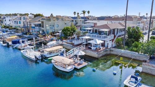 an aerial view of a marina with boats in the water at Stunning Bayfront Home w Epic Dock on Peninsula in Newport Beach