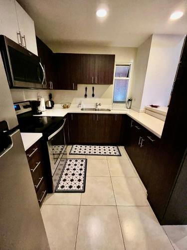 a small kitchen with a sink and a counter at The Brompton's Luxury Apartment in Kingston