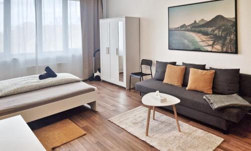 a living room with a couch and a table at WO Apartments am Klinikum Wolfsburg in Wolfsburg