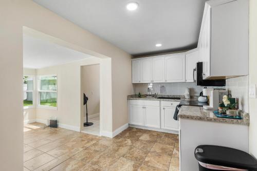 a kitchen with white cabinets and a counter at Private rooms in West Palm Beach - Close to Beaches in West Palm Beach