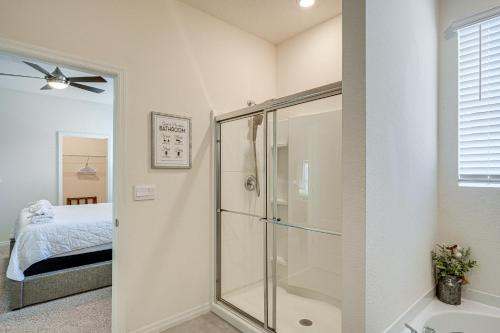 a bathroom with a glass shower and a bed at Disney Area Vacation Rental with Game Room and Pool! in Davenport