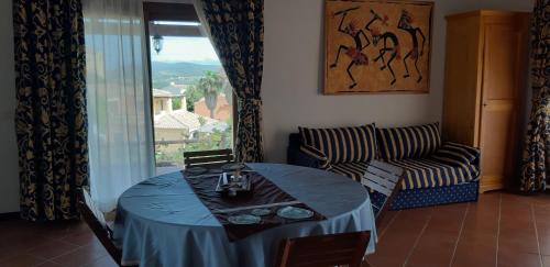 a dining room with a table and a couch at Casa Ethno Stintino-Private pool in Stintino