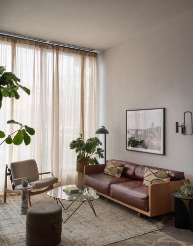 a living room with a brown couch and a table at ROOST Kelly Drive in Philadelphia