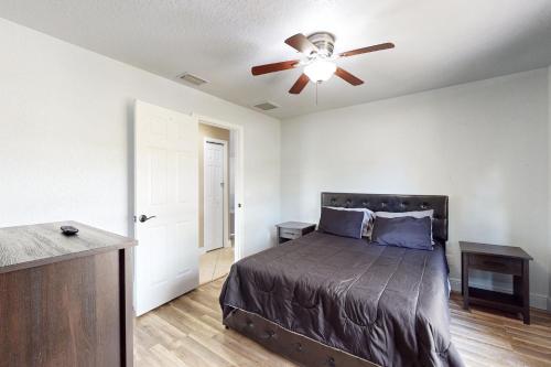 a bedroom with a bed and a ceiling fan at #1 in North Port in North Port