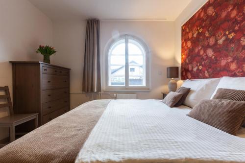 a bedroom with a large bed with a large window at Wellness Pension Fulda Černý Důl in Cerny Dul