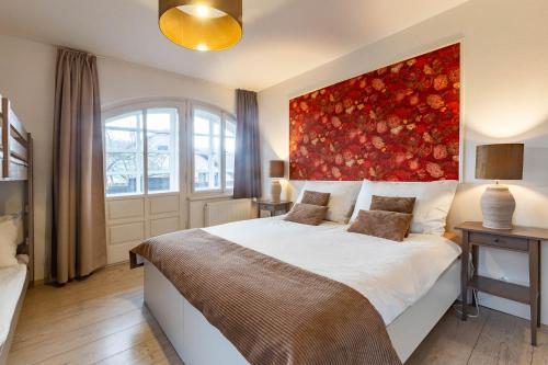 a bedroom with a large bed with a red painting on the wall at Wellness Pension Fulda Černý Důl in Cerny Dul