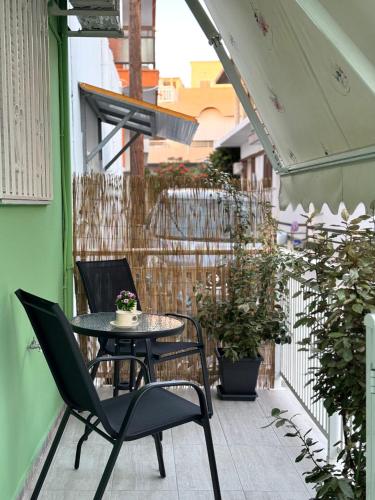 a patio with a table and chairs on a balcony at Aesthetic Cozy Haven in Kremasti