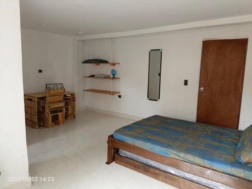a bedroom with a bed and a desk in it at El Paso Gh #3 in Guarne