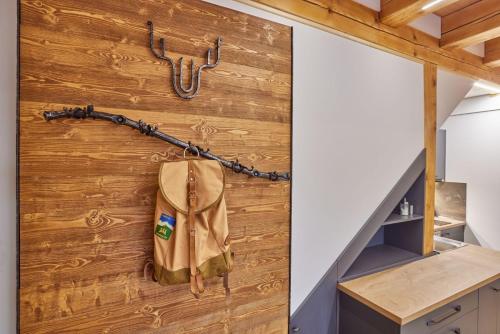 a wooden wall with a bag hanging on it at Urlas Apartments, dog friendly, shortcut to Sněžka Mountain in Pec pod Sněžkou