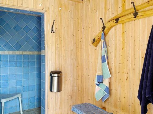 a bathroom with blue tile walls and a towel at Holiday home GRÄSÖ II in Gräsö