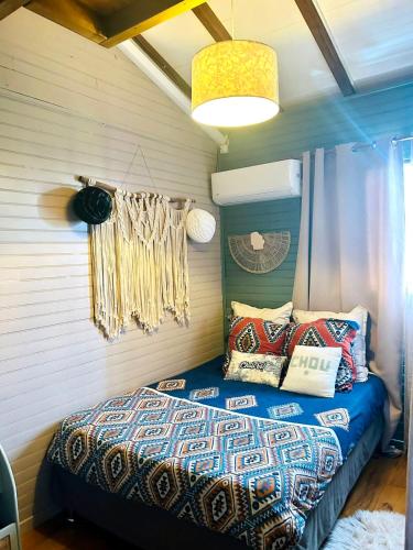 a bedroom with a bed with pillows on it at Lodge karibea in Saint-François