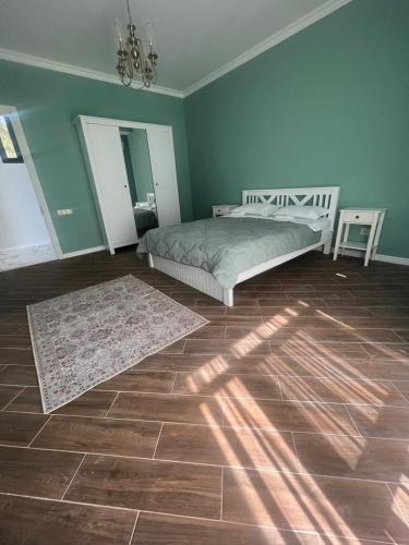 a bedroom with a bed and a rug on the floor at Sunrise Grigoleti in Grigoleti