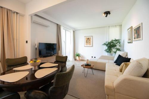 a living room with a couch and a table at Cozy apartment with a beautiful view in Split