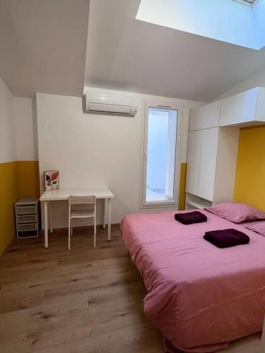 une chambre avec deux lits, une table et un bureau dans l'établissement Appartement grand confort 3 chambres avec cour intérieure, à Marseille