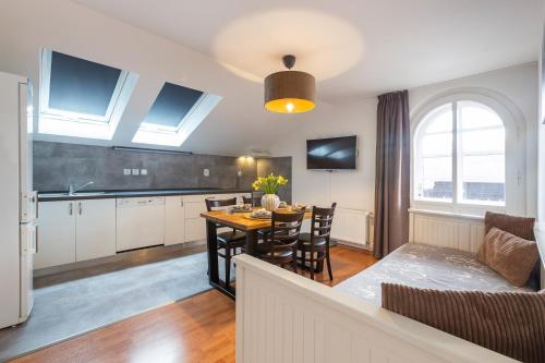a kitchen and living room with a table and a couch at Wellness Pension Fulda Černý Důl in Cerny Dul