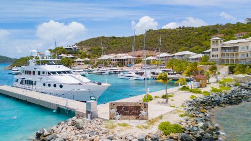 a boat docked at a marina in a resort at Scrub Island Resort, Spa & Marina in The Mill