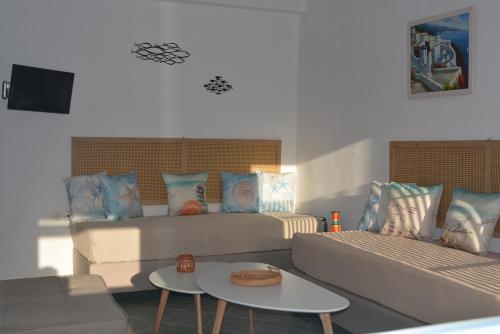 a living room with a couch and a table at Klados Studios & Apartments in Cherronisos