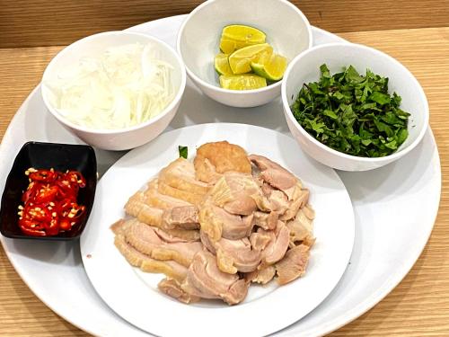 a plate with meat and other ingredients on a table at Hotel Yah Hanoi & Spa in Hanoi