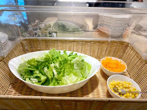 a tray with two bowls of lettuce and other vegetables at Hotel Yah Hanoi & Spa in Hanoi