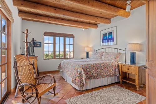 a bedroom with a bed and a desk and a chair at Quail run in Santa Fe