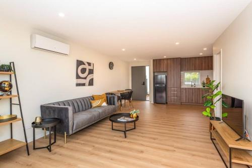 a living room with a couch and a table at Hop, Skip, Jump to the city ! in Christchurch