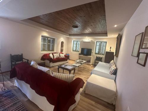 a living room with a couch and a table at Πυργοσπιτο Χαντζακου in Gythio