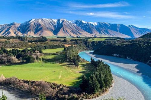 an aerial view of a river with mountains in the background at Spacious Family Home in Kirwee