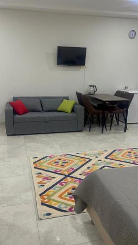 a living room with a couch and a table at Sunrise Grigoleti in Grigoleti