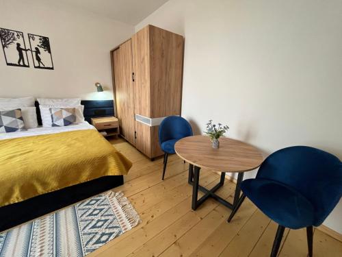 a bedroom with a bed and a table and chairs at Arevaham Boutique Hotel in Stepʼanavan
