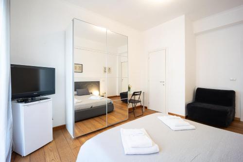 a bedroom with a bed and a large mirror at Mirabella Apartment in Rome