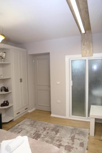 a white room with a door and a window at Vila Emre in Korçë