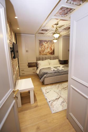 a bedroom with a bed and a painting on the ceiling at Vila Emre in Korçë